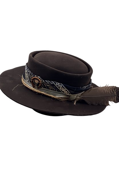 Black cowboy hat with bandana and feather on a white background