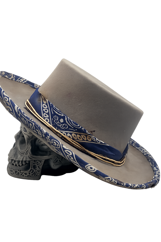 Gray cowboy hat with blue bandana around the brim on a white background